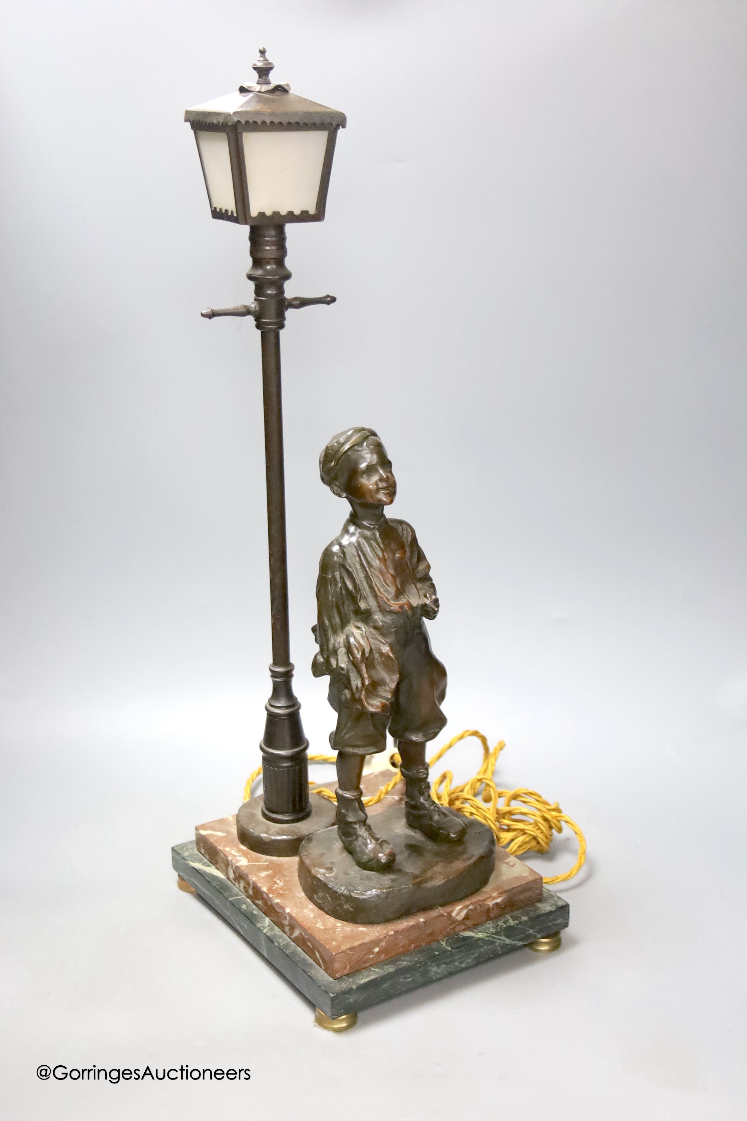A bronze desk lamp, a boy standing beneath a street lamp, signed, height 62cm